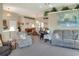 Bright living room featuring plush furniture, a dining area, and elevated shelving at 5857 Macaw Pl, Lakeland, FL 33809