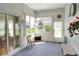 Sunroom area with light blue textured walls, and lots of natural light through the windows at 5857 Macaw Pl, Lakeland, FL 33809