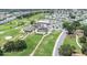 Aerial view of a community clubhouse, pool, tennis courts, and the adjacent golf course at 6001 Condor Dr, Lakeland, FL 33809