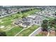 Aerial view of a community with golf course, clubhouse, pool, and tennis courts at 6001 Condor Dr, Lakeland, FL 33809
