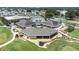 Aerial view of community clubhouse and golf course with parking and green space at 6001 Condor Dr, Lakeland, FL 33809