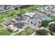 Community aerial view showcasing golf amenities, tennis courts, a pool, and ample parking at 6001 Condor Dr, Lakeland, FL 33809