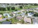 Aerial view featuring a home in a community with a golf course and meticulously maintained lawns at 6001 Condor Dr, Lakeland, FL 33809
