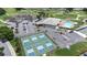 Aerial view of community featuring pickleball courts, pool, clubhouse, parking and golf course at 6001 Condor Dr, Lakeland, FL 33809