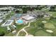 Aerial view of the community including golf course, pool, clubhouse, and pickleball courts at 6001 Condor Dr, Lakeland, FL 33809