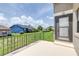 Cement back porch with view of the backyard and blue house in the distance at 6001 Condor Dr, Lakeland, FL 33809