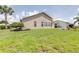 Manicured lawn with tropical foliage in the back of the property at 6001 Condor Dr, Lakeland, FL 33809