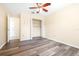 Bedroom with hardwood floors, ceiling fan, closet, and ensuite bathroom at 6001 Condor Dr, Lakeland, FL 33809