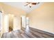 A bright bedroom with hardwood floors, ceiling fan, closet, and ensuite bathroom at 6001 Condor Dr, Lakeland, FL 33809