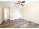 Bedroom with a ceiling fan, hardwood floors and a spacious closet at 6001 Condor Dr, Lakeland, FL 33809