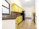 The kitchen features black appliances and bright yellow cabinets at 6001 Condor Dr, Lakeland, FL 33809
