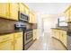 Well-equipped kitchen featuring stainless steel appliances and bright yellow cabinets at 6001 Condor Dr, Lakeland, FL 33809