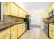 The kitchen features a stainless steel sink and bright yellow cabinets at 6001 Condor Dr, Lakeland, FL 33809