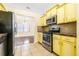 The kitchen features a stainless steel stove and bright yellow cabinets at 6001 Condor Dr, Lakeland, FL 33809