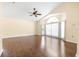 Spacious living room featuring vaulted ceilings, hardwood floors, a fan, and plentiful natural light at 6001 Condor Dr, Lakeland, FL 33809