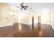 Spacious living room featuring vaulted ceilings, hardwood floors, a fan, and plentiful natural light at 6001 Condor Dr, Lakeland, FL 33809