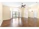 Spacious living room featuring vaulted ceilings, hardwood floors, a fan, and plentiful natural light at 6001 Condor Dr, Lakeland, FL 33809