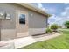Side door entrance with a small landscaped area and walkway at 6001 Condor Dr, Lakeland, FL 33809