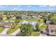 Aerial view of home with lake views, mature landscaping and a fenced yard at 619 Somerset Loop, Auburndale, FL 33823