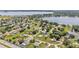 Aerial view of homes in residential neighborhood near lake at 619 Somerset Loop, Auburndale, FL 33823