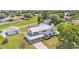 Aerial view of property with metal roof, fenced yard, mature landscaping and adjacent garage at 619 Somerset Loop, Auburndale, FL 33823