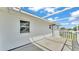 Back porch features vinyl siding, a window, a railing, a concrete floor, and a covered overhead trellis at 619 Somerset Loop, Auburndale, FL 33823