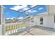 Covered back porch features a railing overlooking a pool, an exit door, vinyl siding and a concrete floor at 619 Somerset Loop, Auburndale, FL 33823