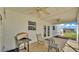 Outdoor porch featuring a grill, seating, concrete floor, an exterior door, vinyl siding and a double ceiling fan at 619 Somerset Loop, Auburndale, FL 33823