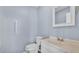 Bathroom features a white vanity and toilet and a grab bar for accessibility at 619 Somerset Loop, Auburndale, FL 33823