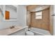 Cozy bathroom featuring a tub with tiled shower, a window, and a white vanity with a sink at 619 Somerset Loop, Auburndale, FL 33823