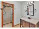 Bathroom with a modern vanity and framed mirror next to glass-enclosed shower at 619 Somerset Loop, Auburndale, FL 33823