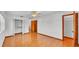 Spacious bedroom featuring hardwood flooring and ample closet space for storage and organization at 619 Somerset Loop, Auburndale, FL 33823