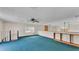 Expansive bonus room with blue carpet, a ceiling fan, and a unique decorative element on the back wall at 619 Somerset Loop, Auburndale, FL 33823