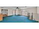 Large bonus room featuring blue carpet, a staircase, a door to the exterior and an abundance of natural light at 619 Somerset Loop, Auburndale, FL 33823