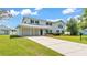 Charming two-story home with attached two-car garage and well-maintained lawn at 619 Somerset Loop, Auburndale, FL 33823