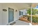 Home's covered front porch with a swing at 619 Somerset Loop, Auburndale, FL 33823