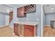 This bar area has wood cabinets, a wine rack, a wine fridge, and light countertops at 619 Somerset Loop, Auburndale, FL 33823