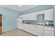 Bright kitchen featuring white cabinets and tiled flooring at 619 Somerset Loop, Auburndale, FL 33823