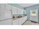 Functional kitchen featuring white cabinets, a refrigerator, sink, and modern appliances at 619 Somerset Loop, Auburndale, FL 33823