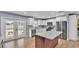 This updated kitchen boasts white cabinets, stainless steel appliances, and island at 619 Somerset Loop, Auburndale, FL 33823