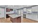 Modern kitchen features stainless appliances, white cabinets, and a spacious center island at 619 Somerset Loop, Auburndale, FL 33823