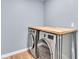 Laundry area featuring wood countertop over stacked washer and dryer at 619 Somerset Loop, Auburndale, FL 33823