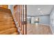 Open-concept living area showcasing wood floors and a modern kitchen with stainless steel appliances at 619 Somerset Loop, Auburndale, FL 33823