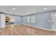 Living room with wood floors, neutral walls, and ample natural light with an adjacent living space at 619 Somerset Loop, Auburndale, FL 33823