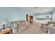 Inviting living room with comfortable seating, ceiling fan, and a view into the adjacent kitchen area at 619 Somerset Loop, Auburndale, FL 33823