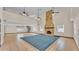 Spacious living room with soaring ceilings, tile flooring, stone fireplace, and spiral staircase at 619 Somerset Loop, Auburndale, FL 33823