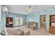 Bright living room features a ceiling fan, tile floors, and ample seating at 619 Somerset Loop, Auburndale, FL 33823
