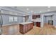 Open concept kitchen/living space with wood floors and modern features at 619 Somerset Loop, Auburndale, FL 33823