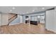 An open-concept space features wood floors connecting kitchen, dining, and living areas at 619 Somerset Loop, Auburndale, FL 33823