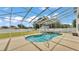 Screened-in kidney-shaped pool features waterfall, pool deck, and spacious backyard perfect for outdoor entertaining at 619 Somerset Loop, Auburndale, FL 33823